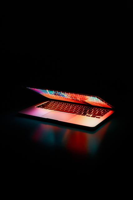 Semi opened laptop computer turned on on table 2047905